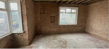 Empty room with plaster removed from walls 